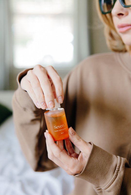 Hands opening an amber skincare product